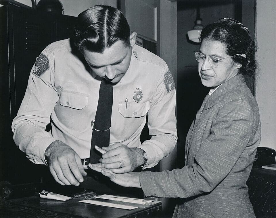Rosa Parks being fingerprinted by a police officer in Montgomery, Alabama after her arrest on December 1, 1955