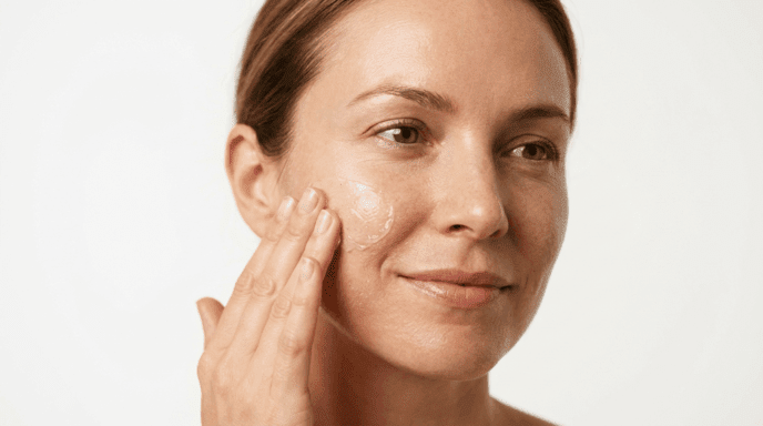 Woman applying glycolic acid gel exfoliant
