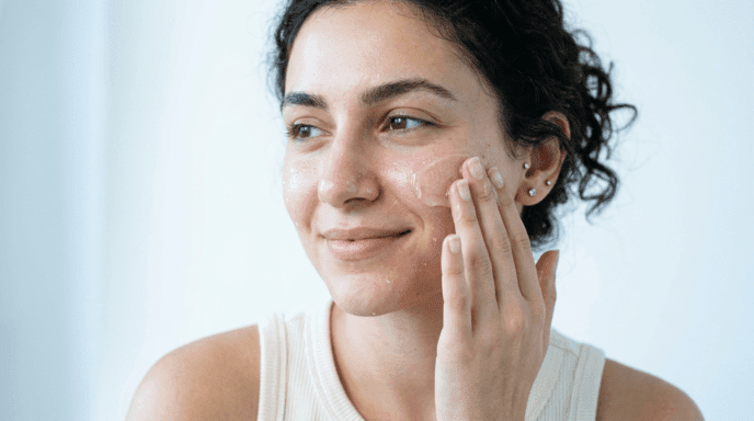 Woman pressing hyaluronic acid serum onto dewy plump skin